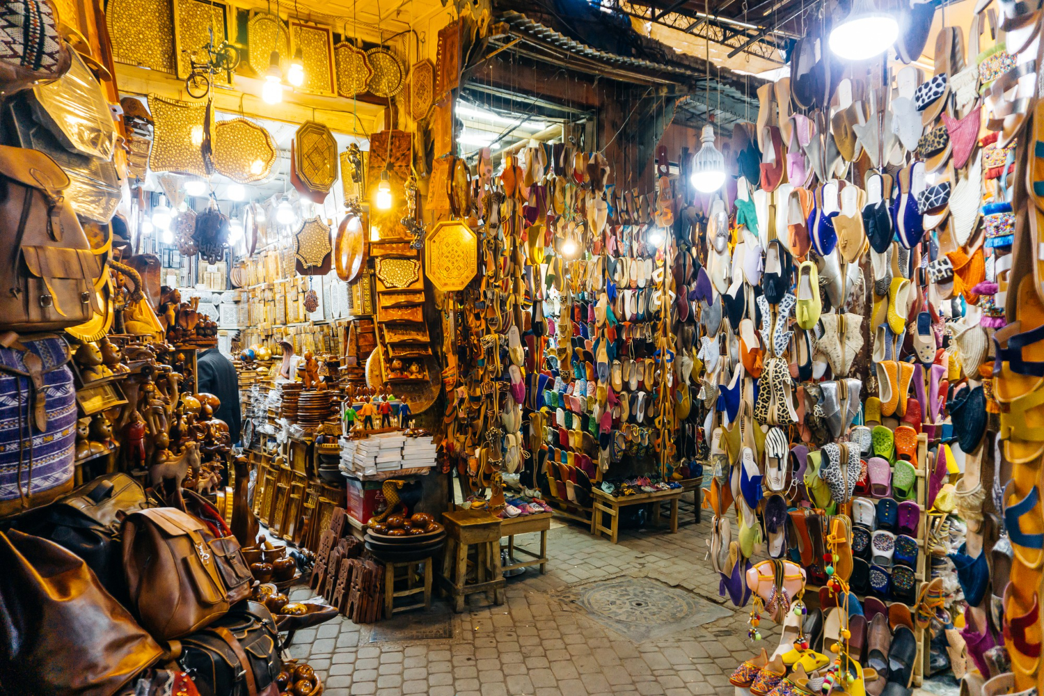 View of handcrafted products for sale in the bustling souks of the historic Medina in Marrakech.